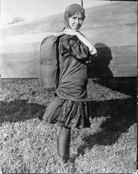 An archival photo of parachute pioneer Tiny Broadwick, posing with her handmade backpack rig.